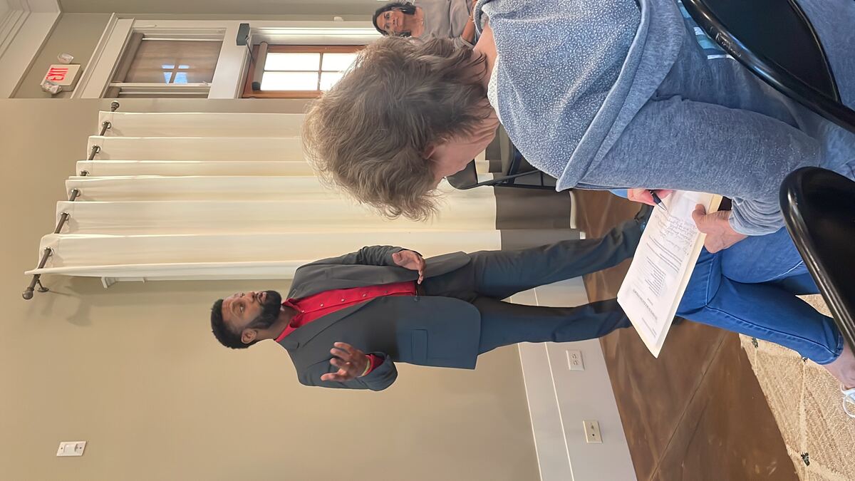 Willie Turral speaking with a community member